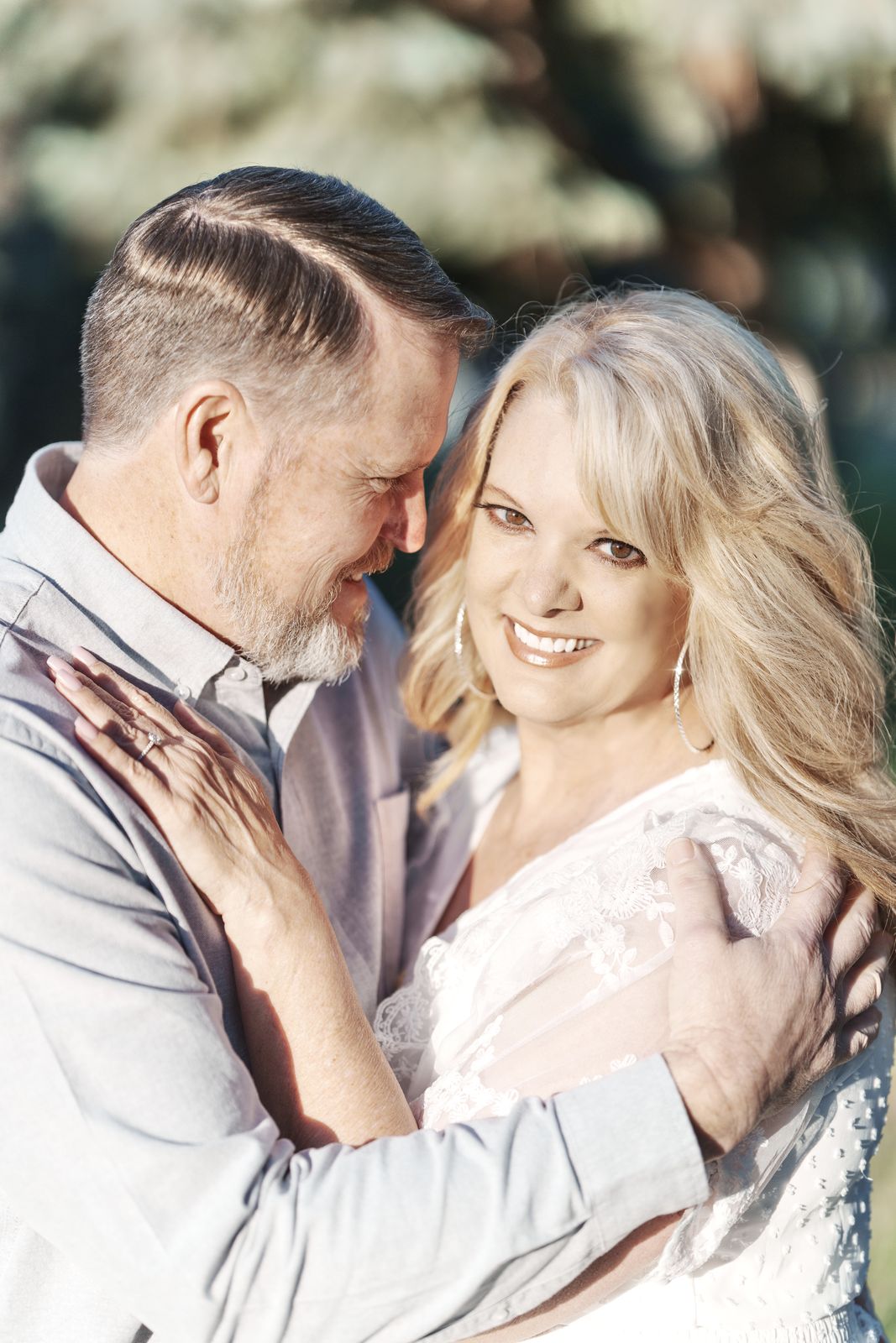 Couple embracing and smiling outdoors